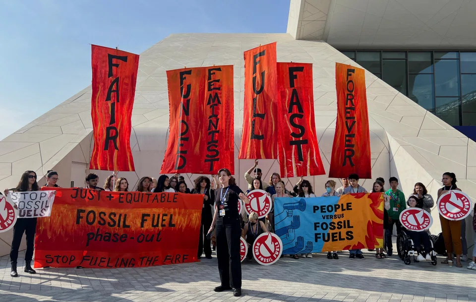 Climate activists protest after a draft of a negotiation deal was released, at the United Nations Climate Change Conference COP28 in Dubai, United Arab Emirates, Dec 13, 2023. 