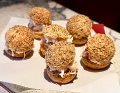 Canape-like black pepper choux puffs are filled with lobster salad.