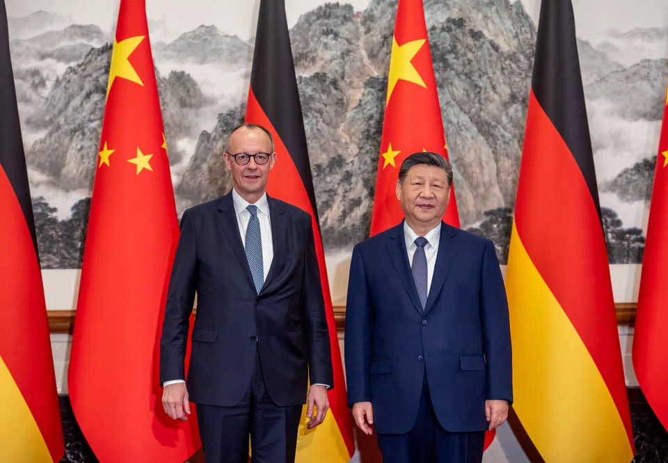 German Chancellor Friedrich Merz (left) and Chinese President Xi Jinping in Beijing on Feb 25. Instead of the West versus China, the real story concerns how middle powers are widening their economic options under Trump-era volatility while keeping their security anchoring intact.