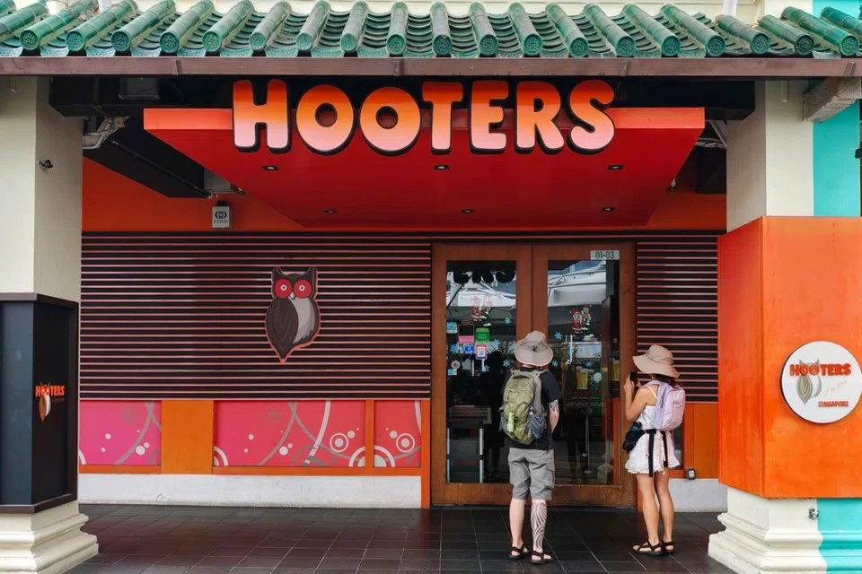 People waiting at around noon on Dec 29 for the Hooters restaurant in Clarke Quay to open. There is no signage outside the outlet about the impending closure.
