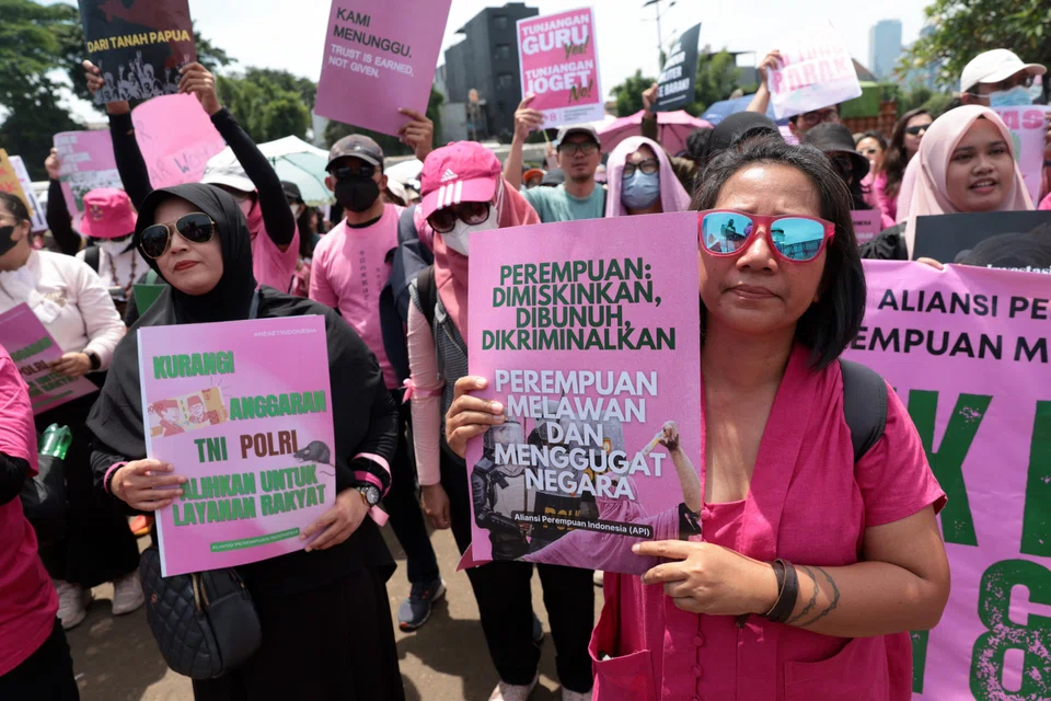 Activists from Indonesia Women’s Alliance hold anti-violence placards in front of Parliament building in Jakarta, Indonesia, Sep 3, 2025. 
