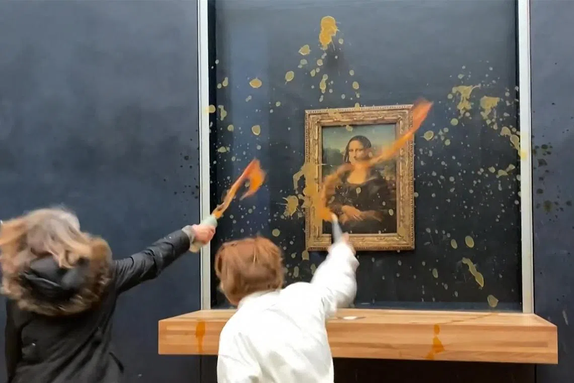 Two environmental activists from the collective Riposte Alimentaire hurling soup at Leonardo Da Vinci's "Mona Lisa" on Jan 28, 2024.