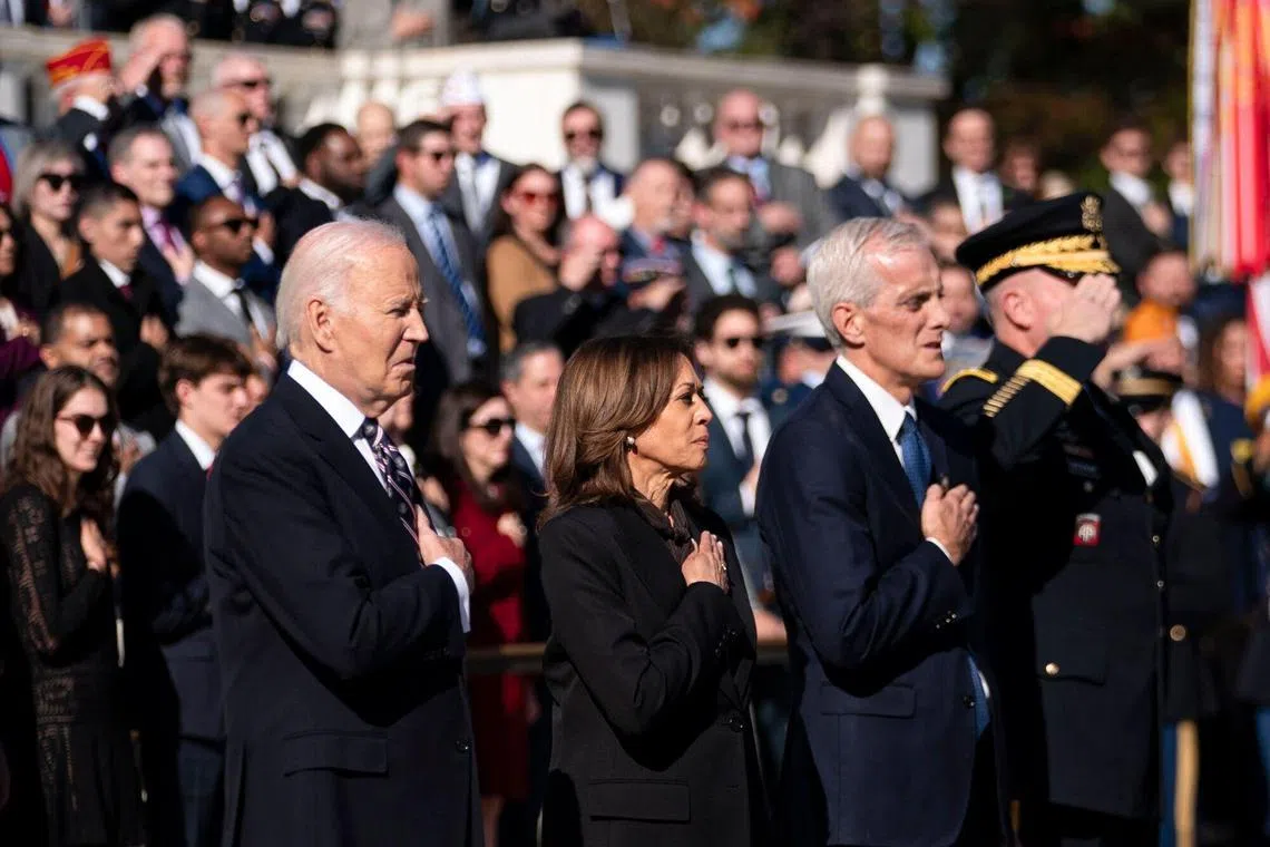 (From left) US President Joe Biden, Vice-President Kamala Harris and US secretary of Veterans Affairs Denis McDonough place their hands over their hearts during a wreath-laying ceremony at the Tomb of the Unknown Soldier at Arlington National Cemetery in Arlington, Virginia, Nov 11, 2024. 