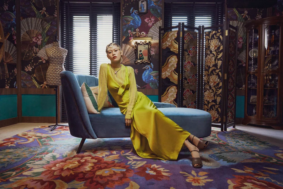 Luka Zhang Lei wears a green dress, mohair pullover and leather heels, all by Fendi, as well as a Serpenti Pallini necklace and ring, both by Bulgari. 
