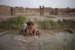 Allah Rakha, a 40-year-old brick moulder, cools off in a groundwater pool during a heatwave in Shujabad, Pakistan, June 4, 2025. 