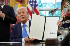 US President Donald Trump after signing a proclamation instituting a US$100,000 fee for visas given to highly skilled foreign workers in the Oval Office, Sep 19, 2025. The Trump administration sought to address the confusion on Saturday by saying that the fee would only apply to new applicants, and renewals or current visa holders would not be affected. 
