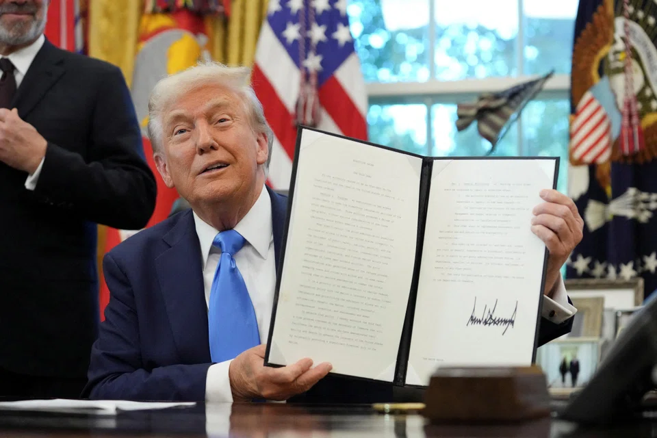US President Donald Trump after signing a proclamation instituting a US$100,000 fee for visas given to highly skilled foreign workers in the Oval Office, Sep 19, 2025. The Trump administration sought to address the confusion on Saturday by saying that the fee would only apply to new applicants, and renewals or current visa holders would not be affected. 