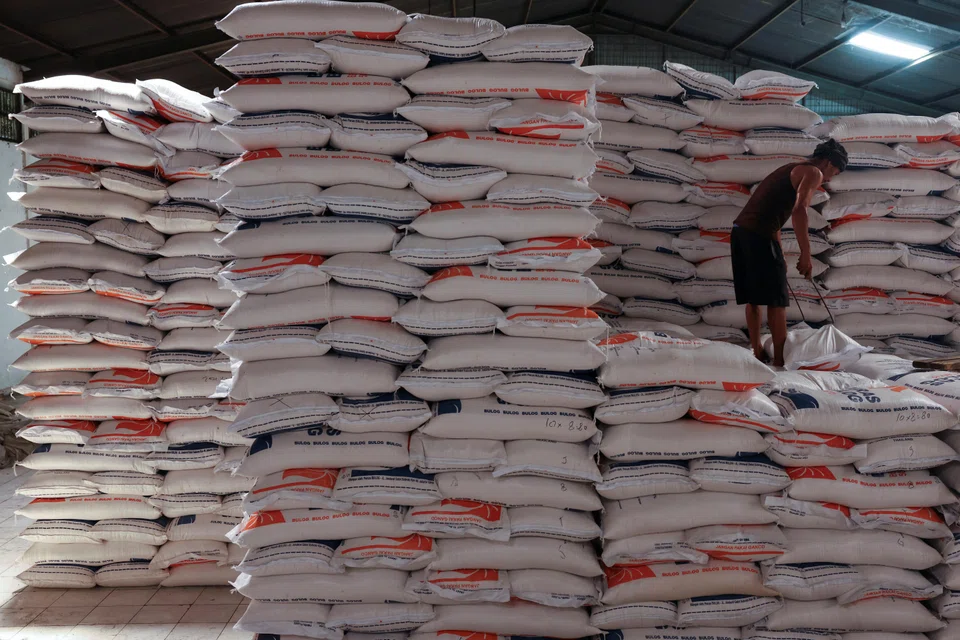 A worker arranges a rice sack at the warehouse in Jakarta, Indonesia, February 13, 2024. REUTERS/Ajeng Dinar Ulfiana