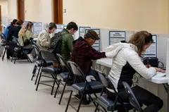 Voters mark their ballots at a polling location inside City Hall during early voting in San Francisco, California, Oct 31, 2024.