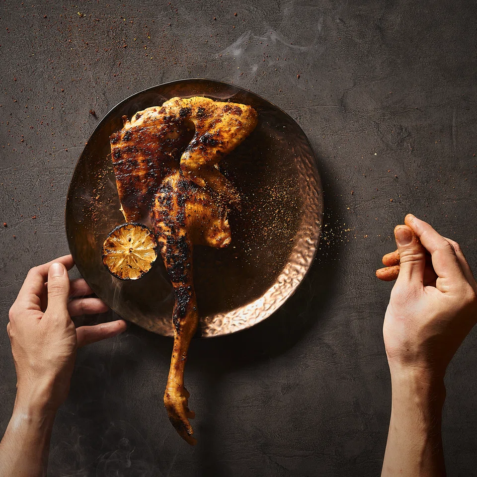 Half a roasted kampong chicken is pepped up with lemon juice and chilli pepper.