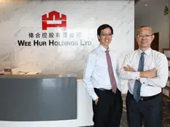 Goh Wee Ping (left, with his father Goh Yeow Lian) sees Wee Hur Holdings' diversification into fund management as a natural progression as it climbs the value chain. 