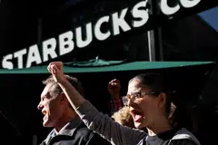 Members of the Starbucks Workers Union and other labour organisations hold a rally outside a company-owned Starbucks store in New York City, US, Nov 16, 2023.