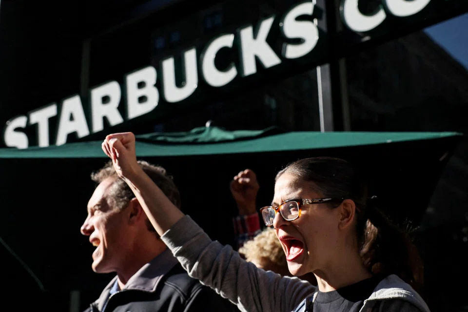 Members of the Starbucks Workers Union and other labour organisations hold a rally outside a company-owned Starbucks store in New York City, US, Nov 16, 2023.
