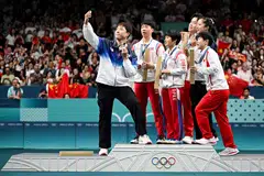 South Korea's Lim Jonghoon takes a selfie with his teammate and Chinese and North Korean mixed table tennis team medallists.