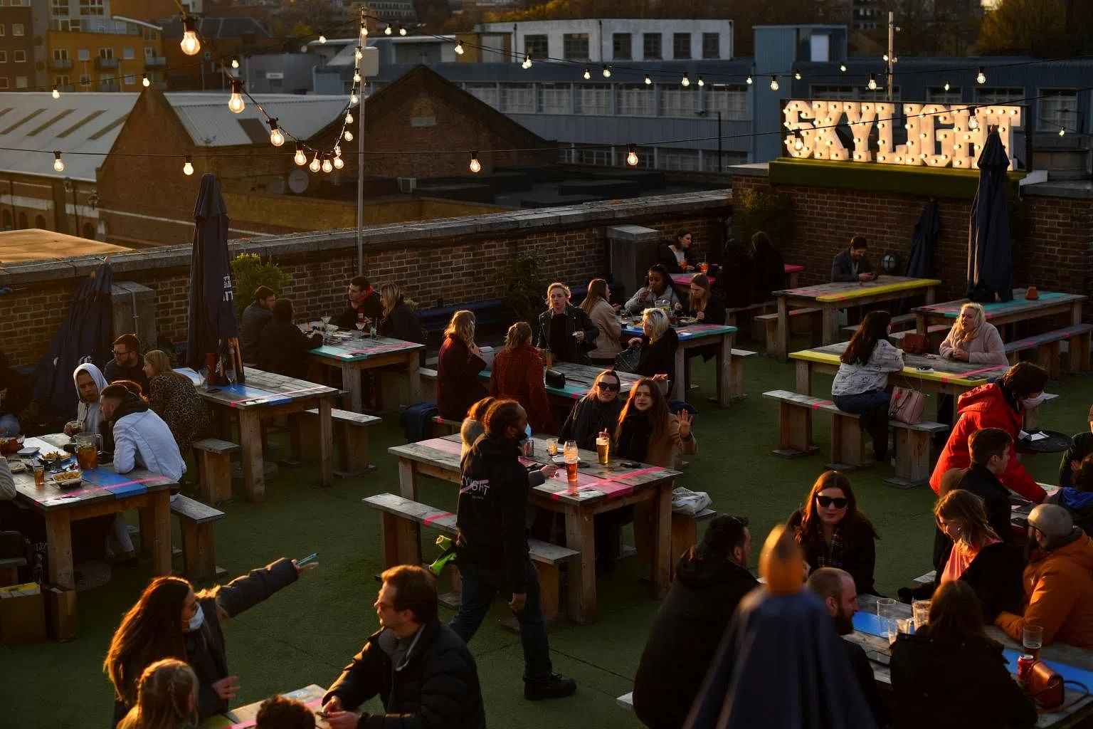 UK hits key vaccine target just as pubs, shops and salons reopen