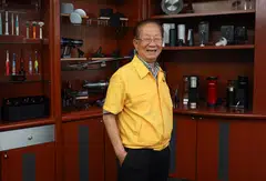 Yao Hsiao Tung, executive chairman of Hi-P Group, framed by products the company has helped to manufacture, either as components or whole products, including Dyson vacuum cleaners and Keurig coffee makers.