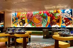 A huge, Chinese-inspired mural covers an entire wall in Quan Hotpot.