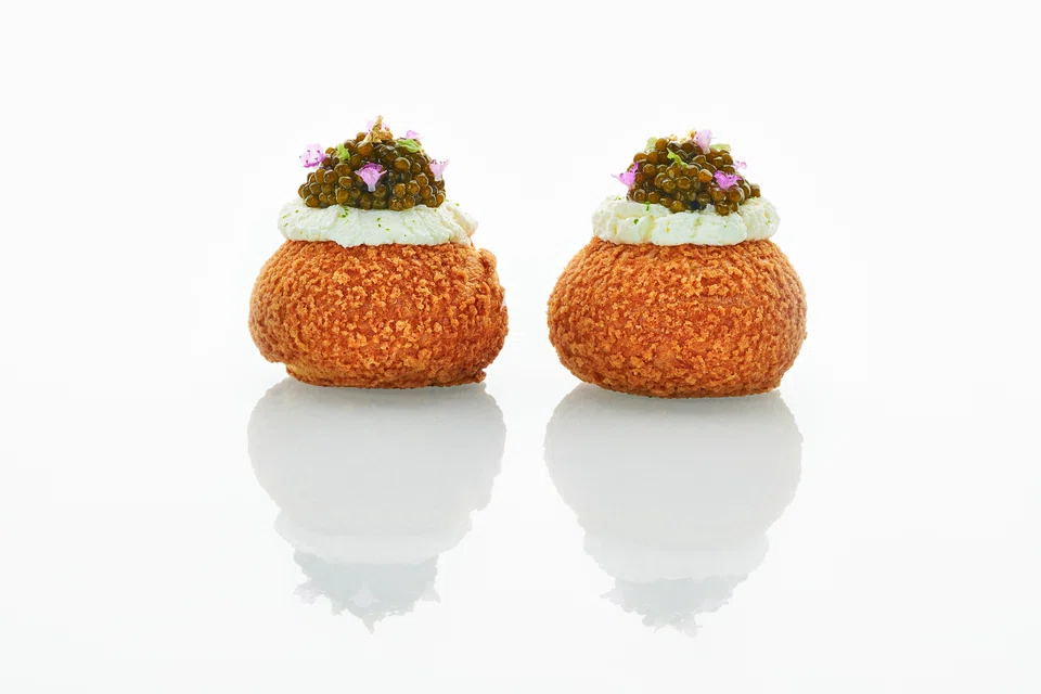 Ami's signature choux puff is filled with creamy egg salad and caviar.