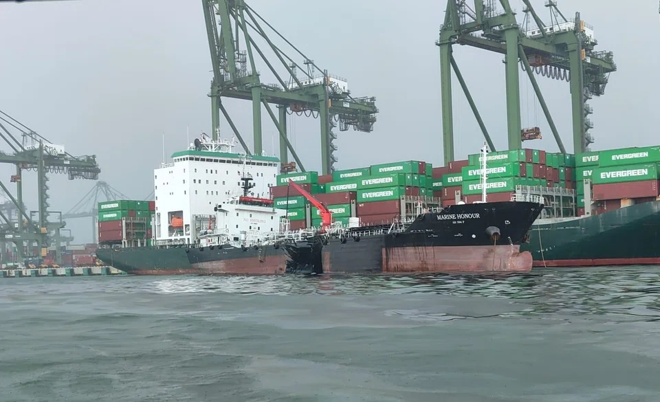 One of the Marine Honour's oil cargo tanks was ruptured on Friday. MPA patrol craft were immediately deployed to spray dispersants on the oil spill. 