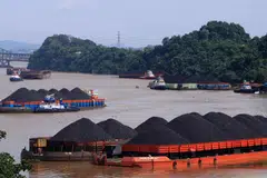 Coal is transported on barges in Indonesia. The country's 660-megawatt Cirebon-1 coal plant will likely cease operations in December 2035 – seven years earlier than its original retirement date of July 2042.