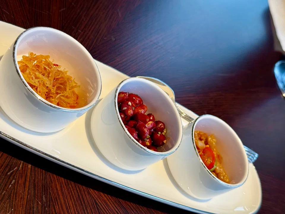 Snacks include preserved radish and vinegared peanuts.