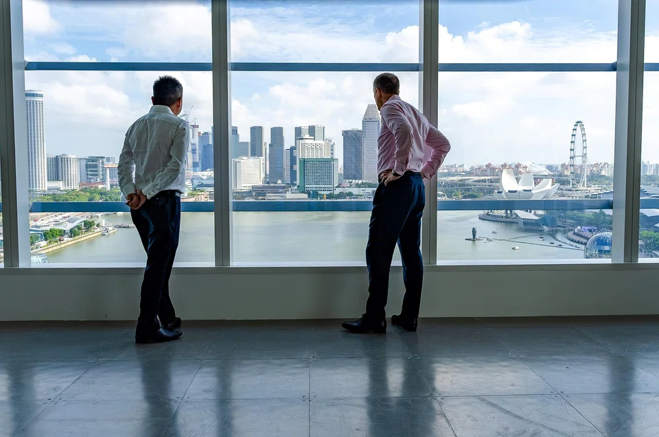 Tay (left) and Armstrong, taking in the panoramic vews of Marina Bay from CBRE's new office. A cafe will be located in this part of the office.