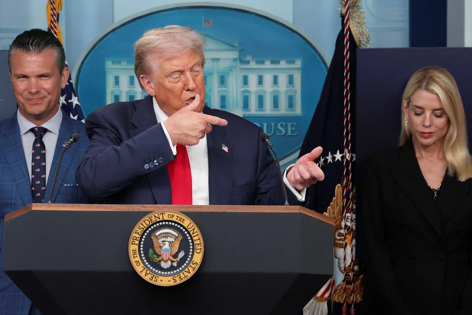 US President Donald Trump gestures as he speaks about Javelin anti-tank missiles next to US Defence Secretary Pete Hegseth (left) and US Attorney General Pam Bondi (right) during a press conference about deploying federal law enforcement agents in Washington to bolster the local police presence, Washington D.C., Aug 11, 2025. 