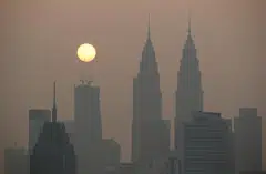 The sun rises above Kuala Lumpur's skyline on a hazy day in Kuala Lumpur, Malaysia, Oct 9, 2023.