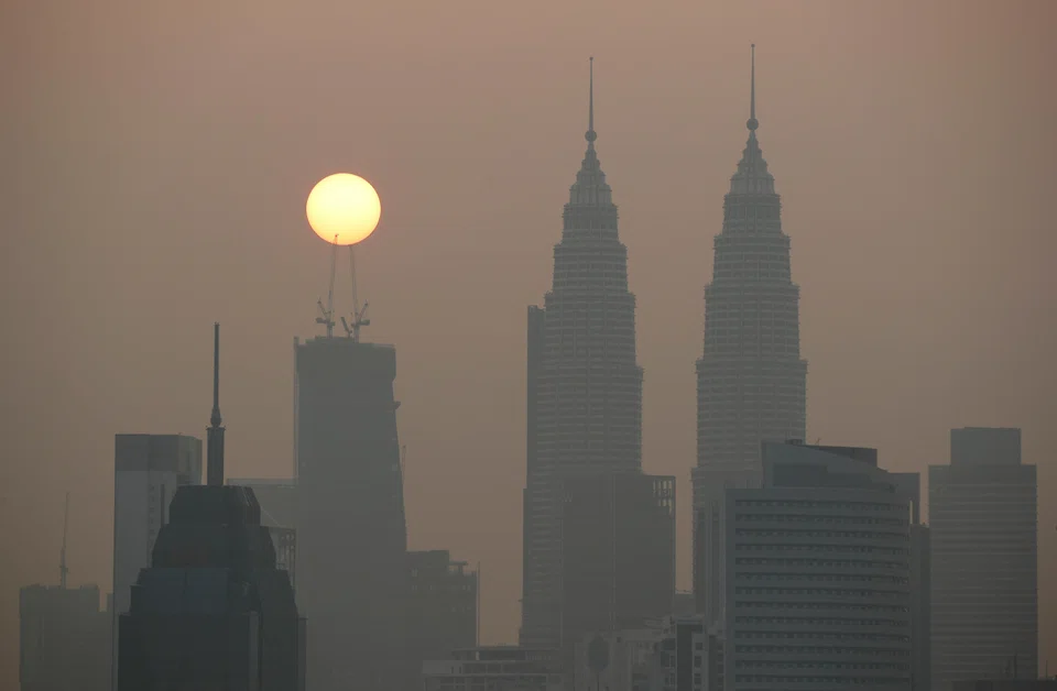 The sun rises above Kuala Lumpur's skyline on a hazy day in Kuala Lumpur, Malaysia, Oct 9, 2023.