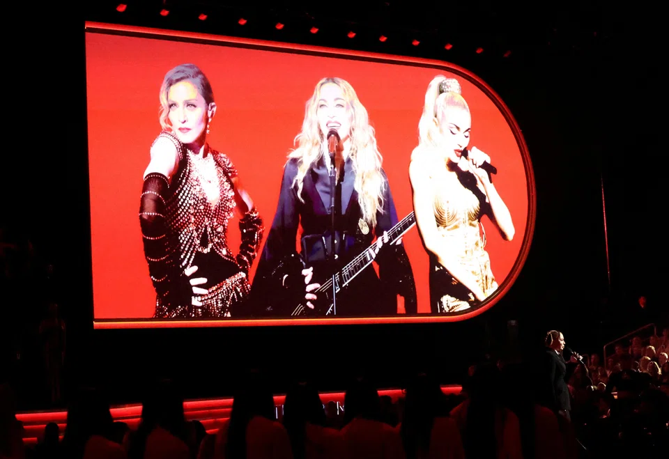Madonna will have 24 onstage performers, four of her children will also be on stage, and she will be  transported high up around the arena “in an illuminated portal frame that acts as a time machine”.