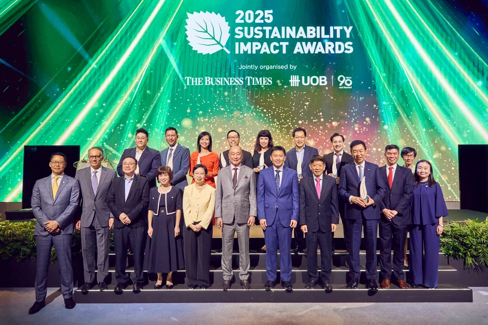 With the winners of the 2025 Sustainability Impact Awards are Minister for National Development Chee Hong Tat (front row, seventh from left), flanked by UOB CEO Wee Ee Cheong (sixth from left) and  SPH Media chairman Khaw Boon Wan.