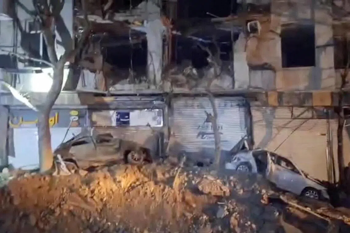 Damage to a building and vehicles in the aftermath of a reported strike, in Teheran, Iran, March 28, 2026