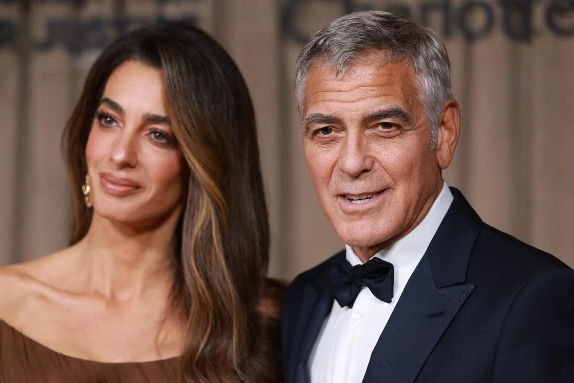 George Clooney (right) and his wife, lawyer Amal Clooney pose on the red carpet of The Albies Awards at the Natural History Museum in London, Britain, Oct 3, 2025. 