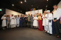 President Tharman Shanmugaratnam (centre), IRO president Noor Marican (with microphone) and other IRO representatives observing a collective prayer for the peace and safety of civilians in Israel and Gaza at the Harmony in Diversity Gallery on Oct 22. 