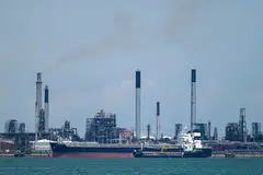 A vessel docks along the Shell Petroleum refineries on Pulau Bukom in Singapore; June 2022.