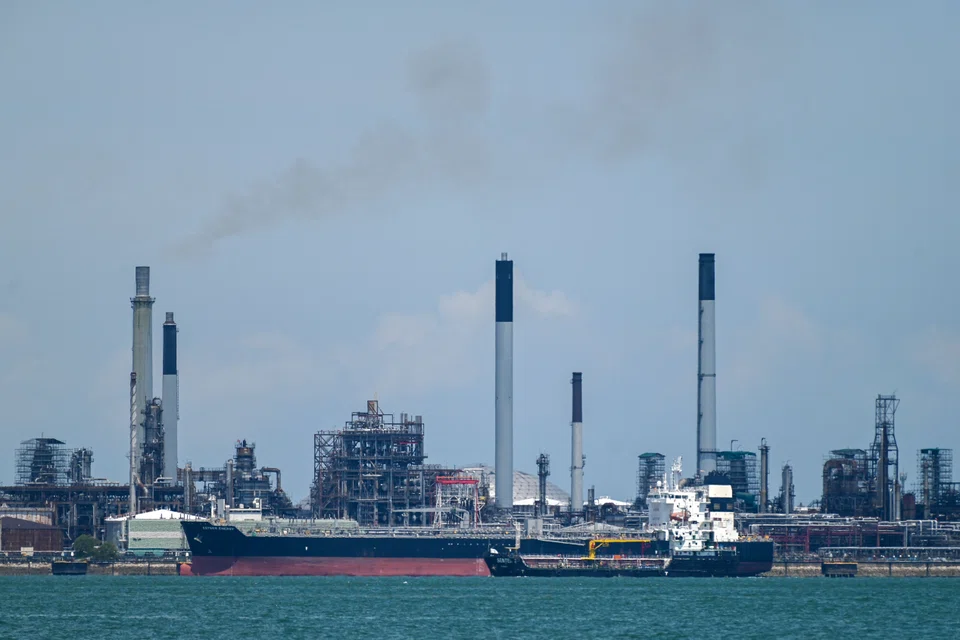 A vessel docks along the Shell Petroleum refineries on Pulau Bukom in Singapore; June 2022.