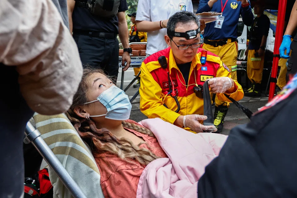 A woman receives medical attention after being rescued from Taroko National Park, following an earthquake, in Hualien, Taiwan.