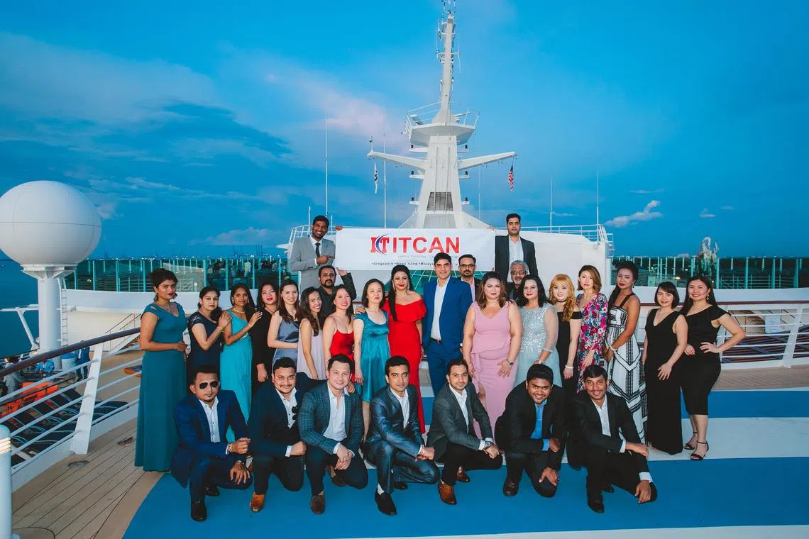 ITCAN chief executive officer Amit Sujan (centre, in blue suit) and IT managing director Sippy Sujan (centre, in red dress) attending a company event with employees. The Sujans see company culture as key to attracting and retaining talent.