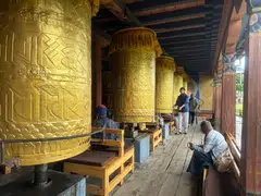 At the National Memorial Chorten, people turn prayer wheels – a spiritual practice believed to accumulate merit and cleanse negative karma.