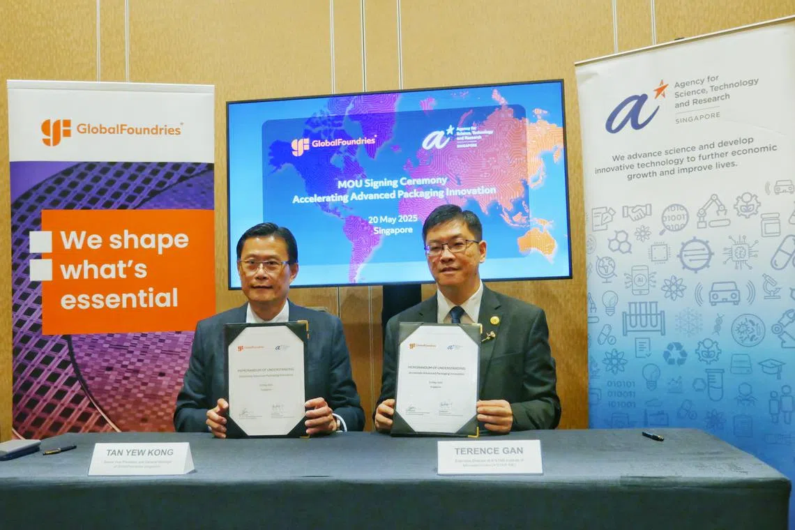 GlobalFoundries Singapore senior vice-president and general manager Tan Yew Kong (left) and A*Star Institute of Microelectronics executive director Terence Gan sign the MOU.