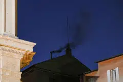 Black smoke rises from the chimney on the Sistine Chapel, indicating no decision has been made to elect a new pope, Vatican, May 7, 2025. 
