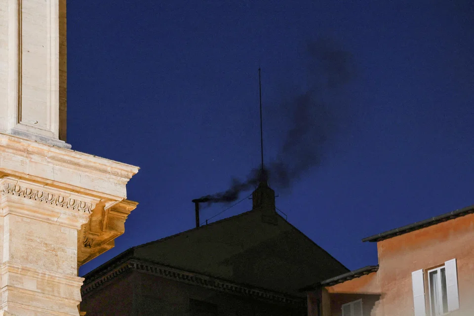 Black smoke rises from the chimney on the Sistine Chapel, indicating no decision has been made to elect a new pope, Vatican, May 7, 2025. 