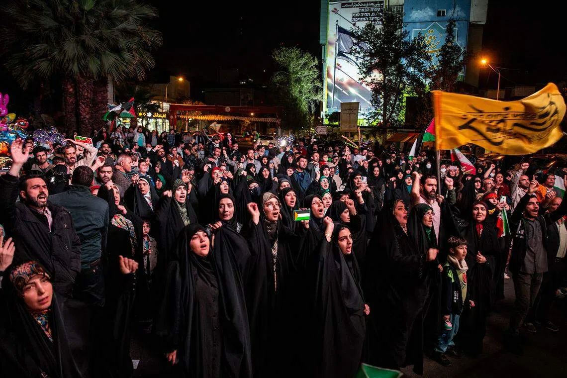 Iranian demonstrators show support during an anti-Israeli gathering at Palestine Square in Tehran, April 14, 2024, after Iran retaliated directly against Israel for the killings of its senior generals in Damascus, Syria, with an onslaught of more than 300 drones and missiles.