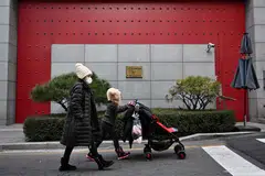 Pedestrians outside the Chinese embassy in Seoul on Jan 10, 2023 - China has suspended the issuing of short-term visas to South Koreans in response to Seoul's imposition of travel curbs on Chinese travellers over Covid concerns.