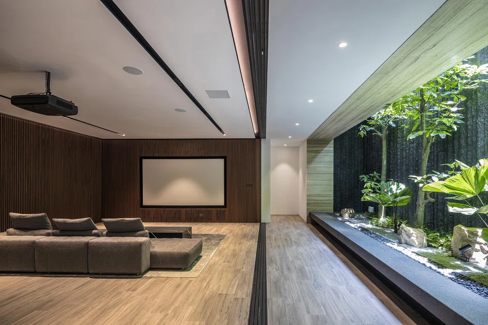 The basement entertainment room faces a garden with a skylight.