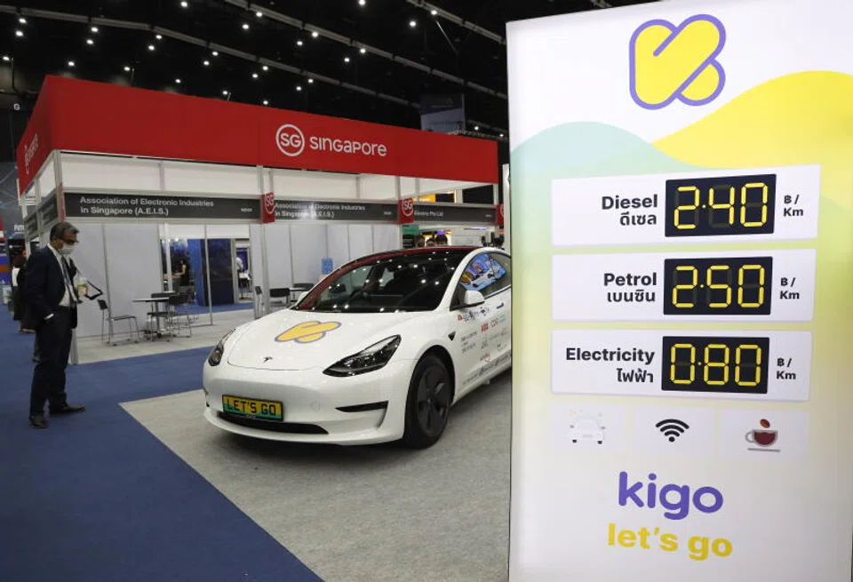 An electric car on display at a recent trade show in Bangkok, next to a board that shows the price of using electricity compared to petrol and diesel. Thailand is rolling out incentives to encourage the manufacturing of EVs in the country.