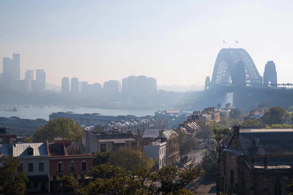 The Sydney Harbour Bridge is seen shrouded by smoke in Sydney, Australia on Sept 13, 2023 after a ring of controlled blazes burned on the city's fringes in preparation for the looming bushfire season. 