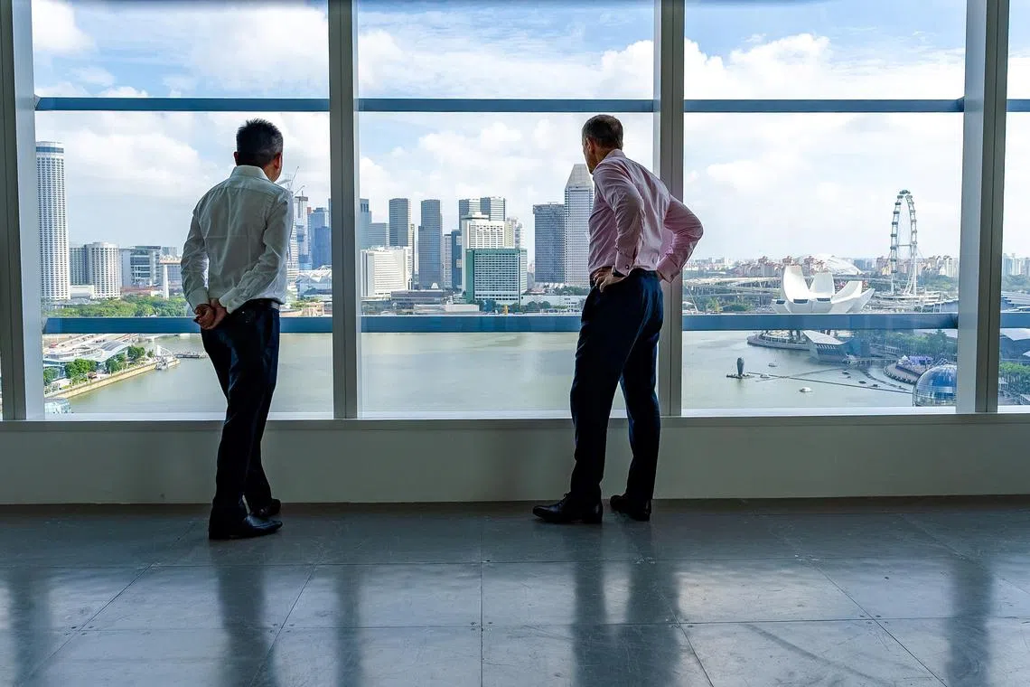 Tay (left) and Armstrong, taking in the panoramic vews of Marina Bay from CBRE's new office. A cafe will be located in this part of the office.