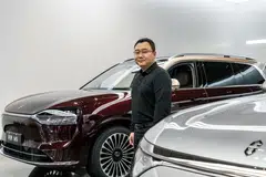 Zhang Zhengping, chairman and president of Seres Group Co., with an Aito M9 SUV at the company's Super Factory in Chongqing on Oct 20. 