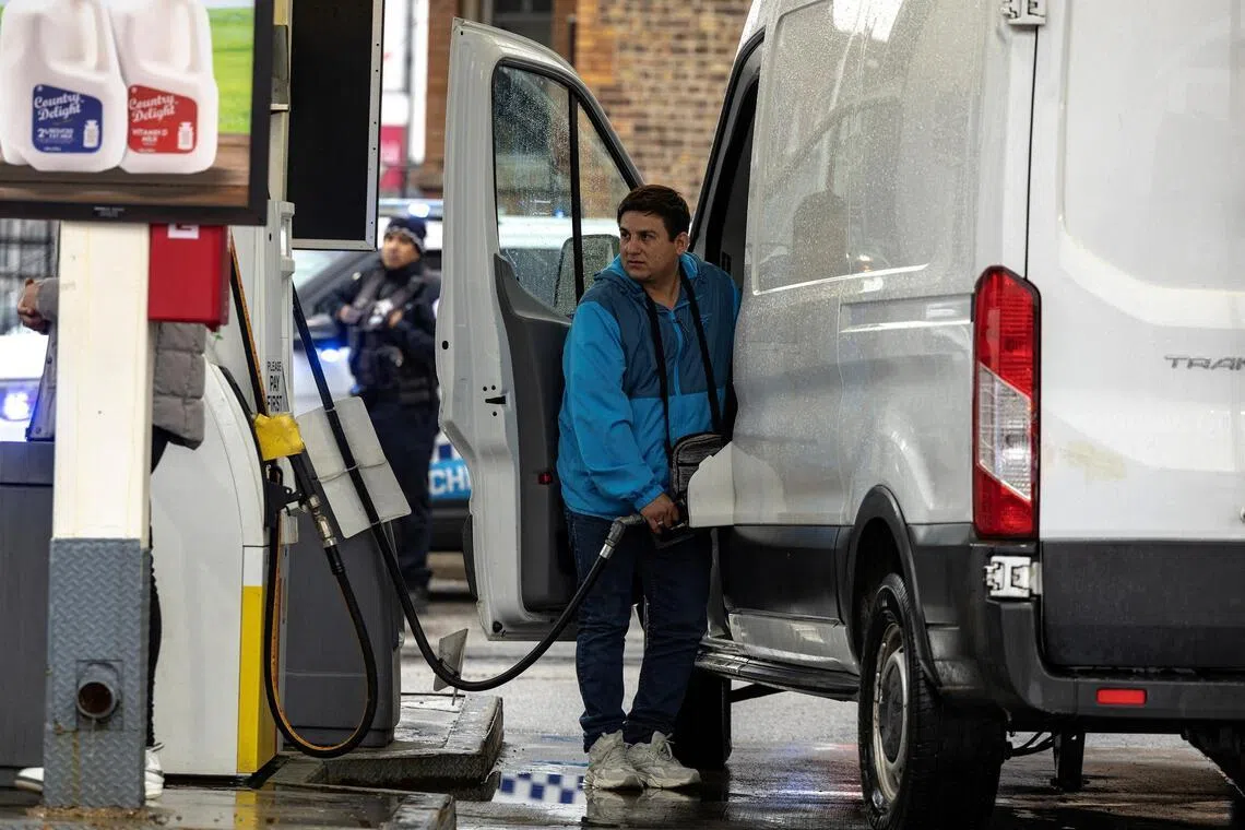 A man fuels up his vehicle at a petrol station in Chicago, Illinois, April 4, 2026. 